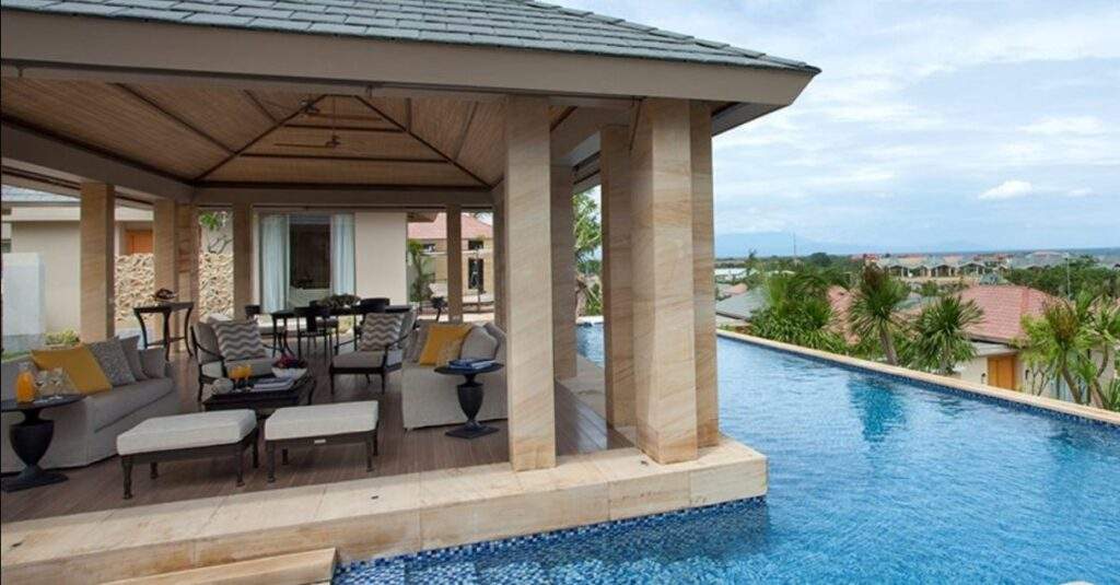 villa with porch and pool surrounding porch