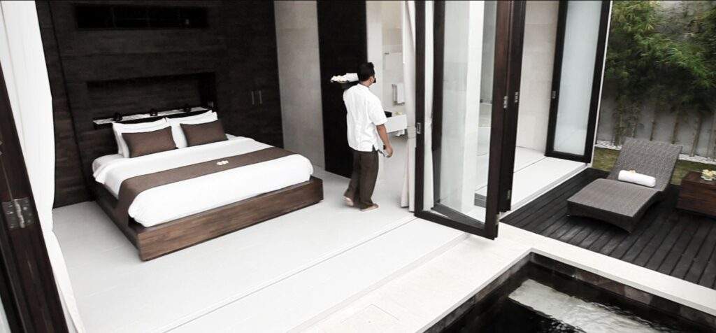 man standing in front of bed