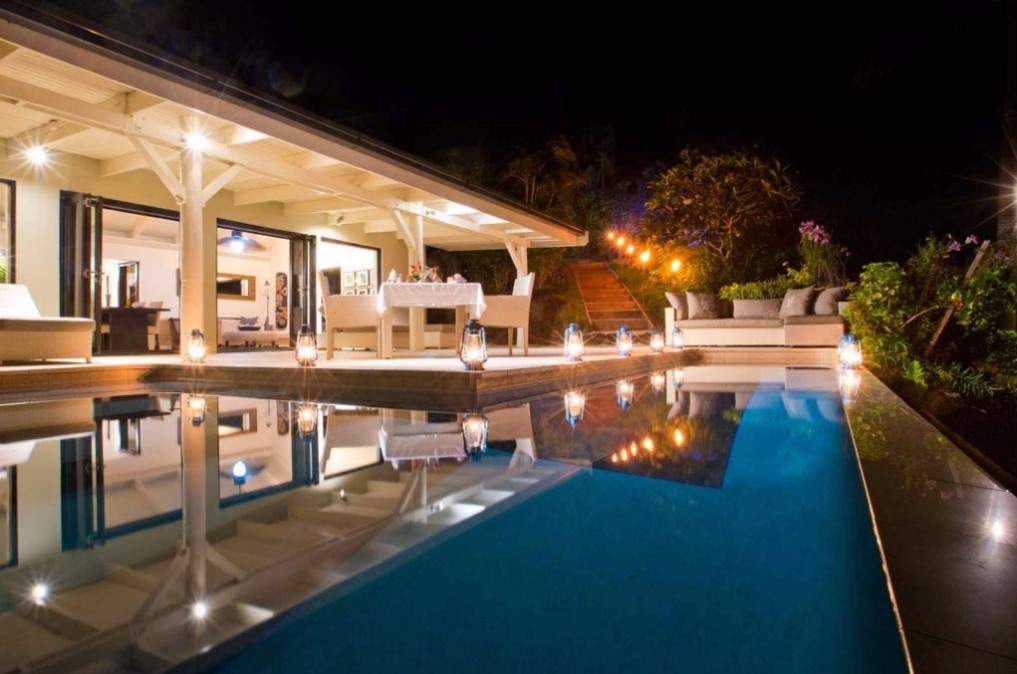 lighted resort room in front of pool at night