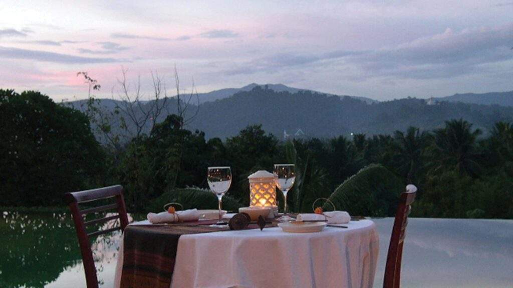 table covered in white tablecloth overlooking mountains