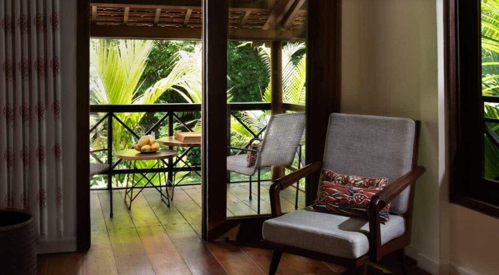 single chair next to open door showing trees