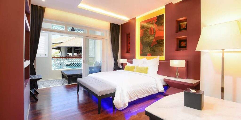 white bed with brown wall behind it