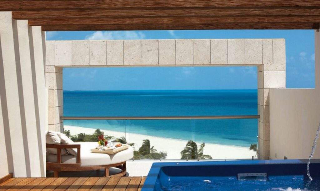 hot tub, table overlooking white sand beach