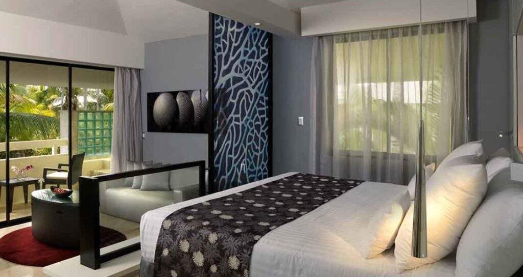 white bed in room with white couch