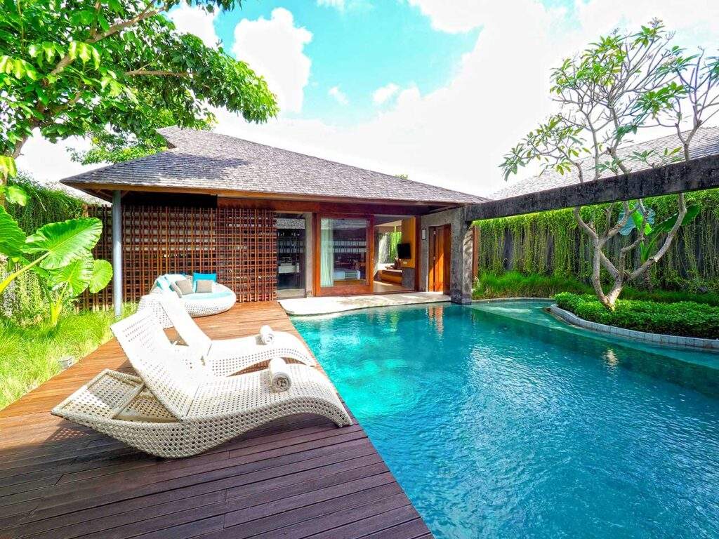 small house behind square swimming pool