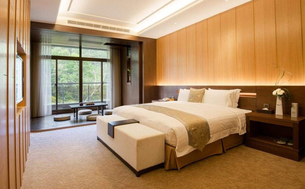 large  resort room with tan walls and large bed