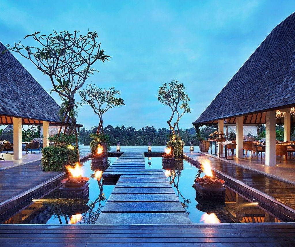wide tropical resort pool at dusk