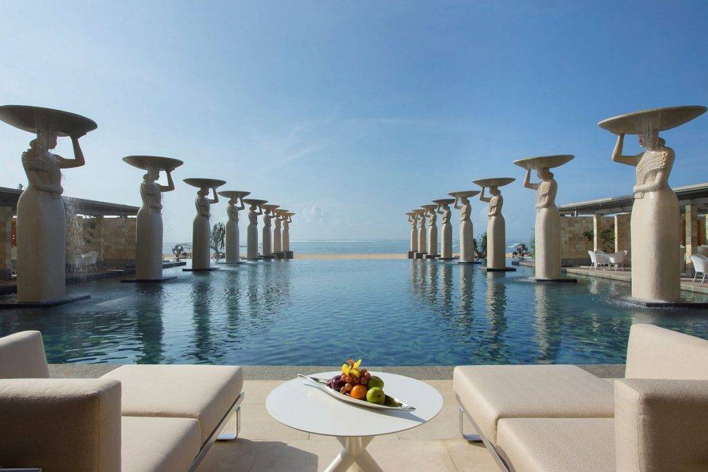 infinity pool with statues lining the sides