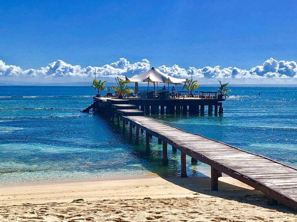 dock leading from beach to ocean