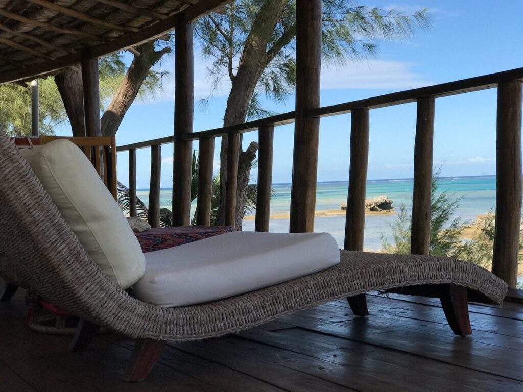 lounge chair on porch overlooking ocean