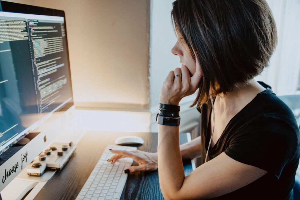 short hair woman reading computer monitor