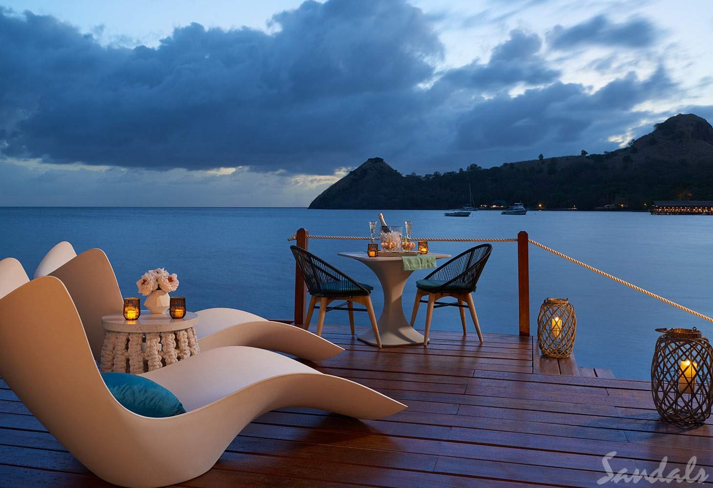 chairs on patio in front of ocean