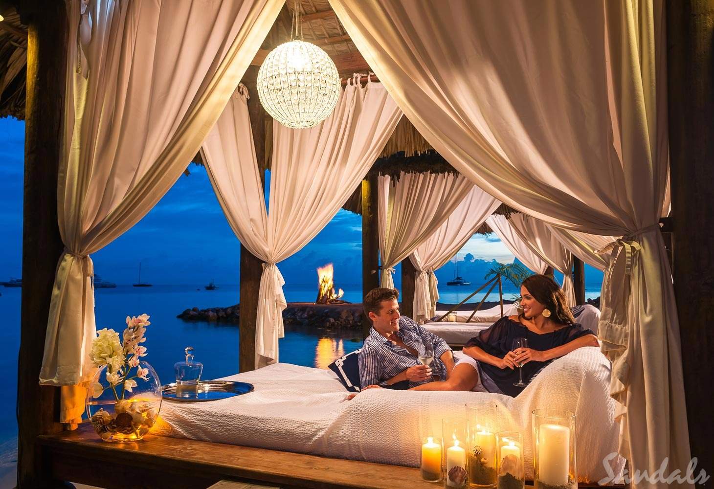 man and woman under cabana at night