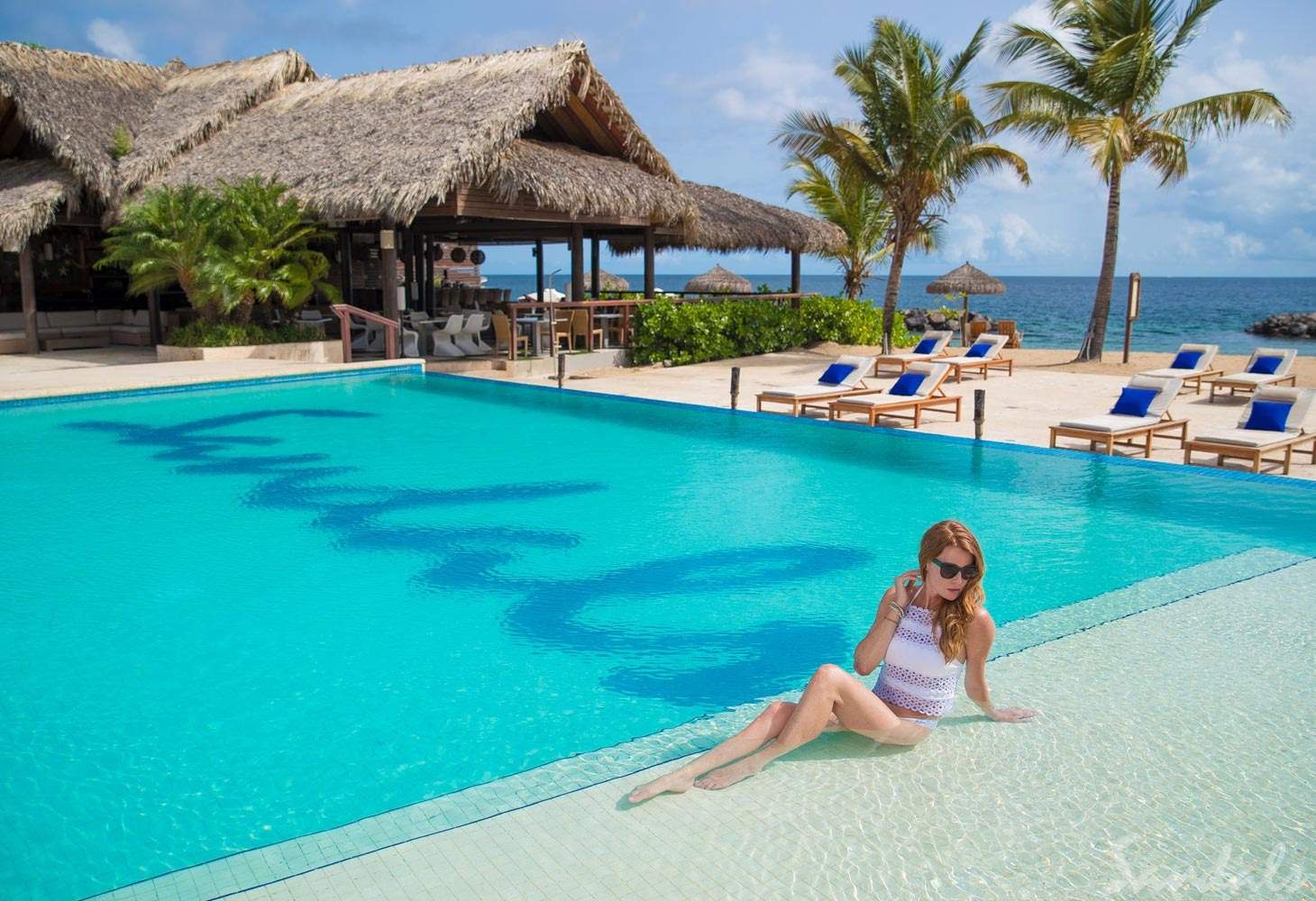 woman sitting by square pool
