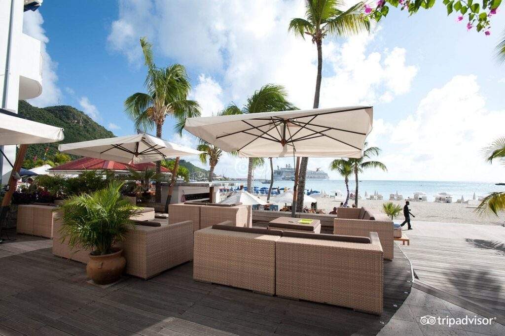 resort couches under umbrellas facing ocean
