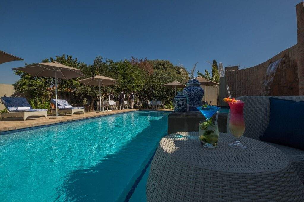 rectangle swimming pool with tress in background