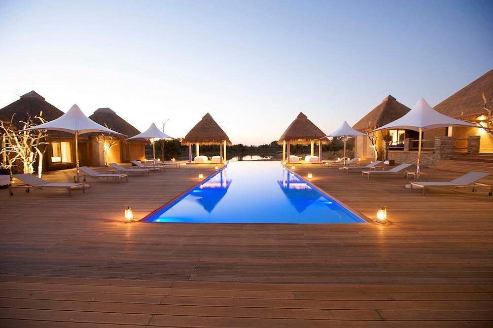 square resort pool surrounded by triangle huts