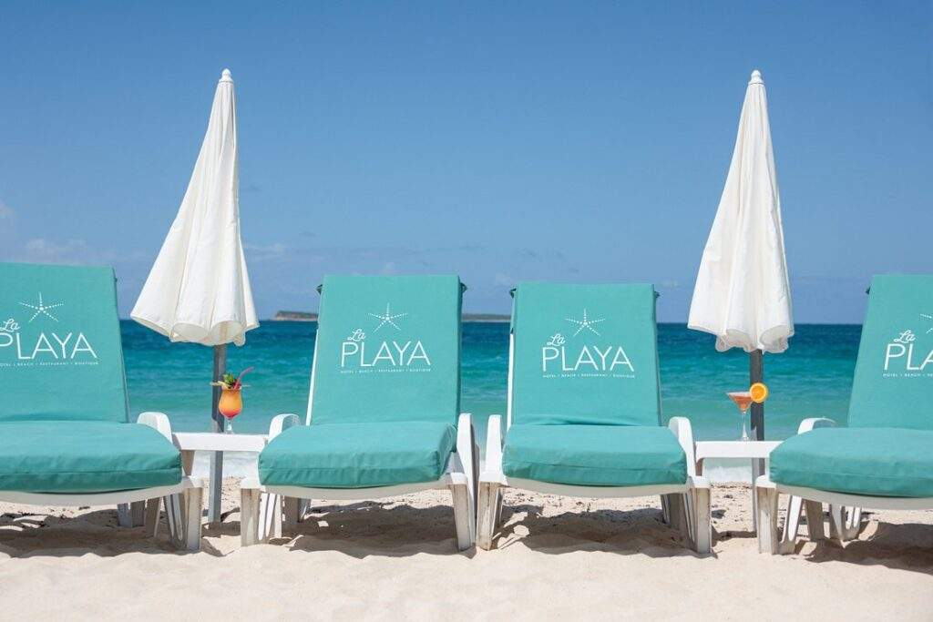 lounge chairs with umbrellas on the beach