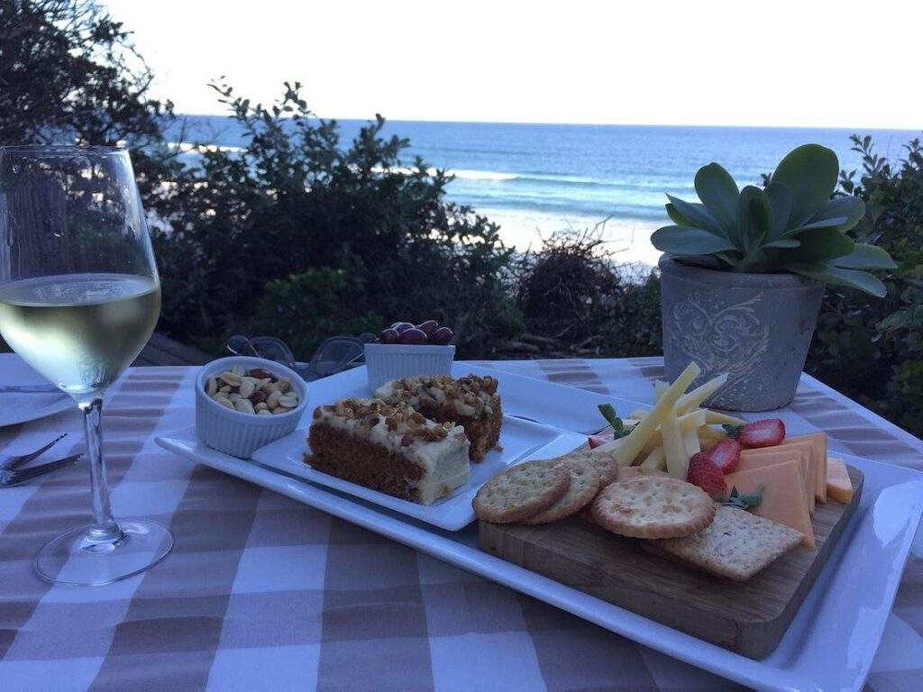 food on plate on table with ocean in background