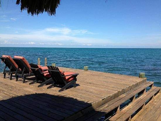 lounge chairs on wooden deck overlooking ocean