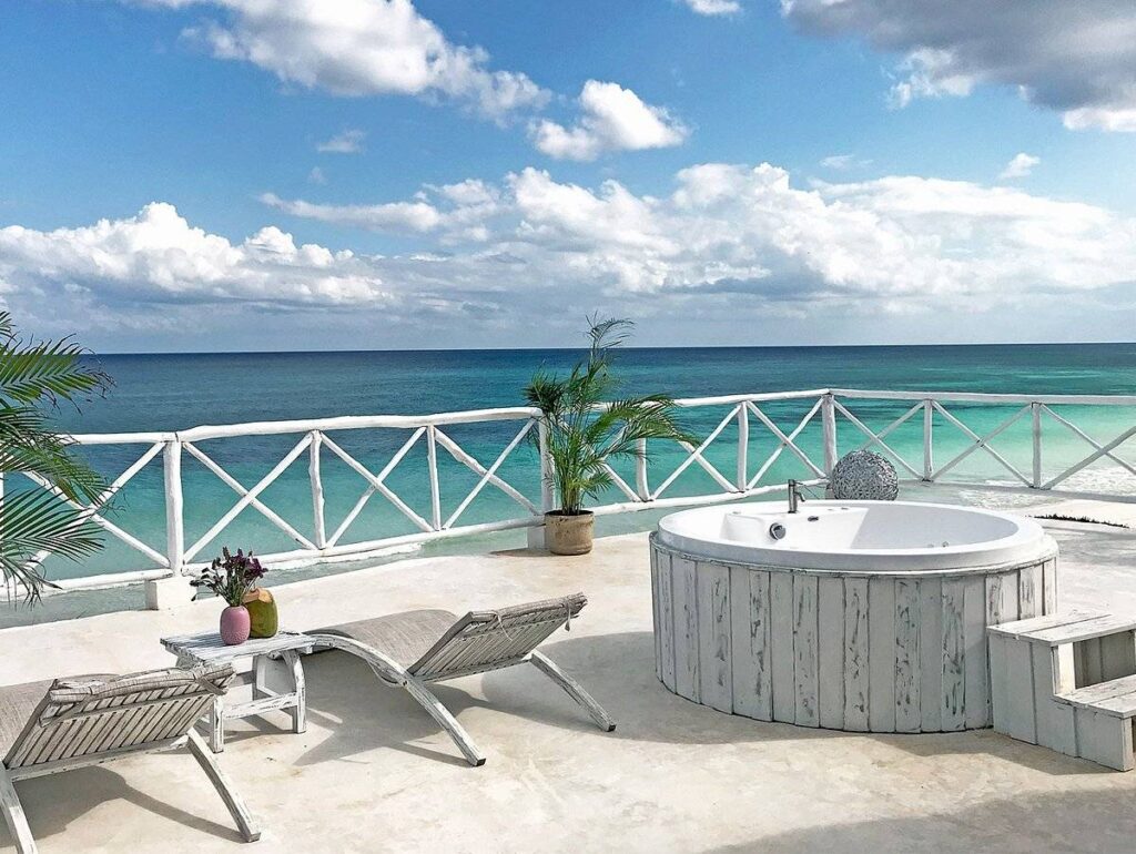resort patio with hot tub overlooking ocean