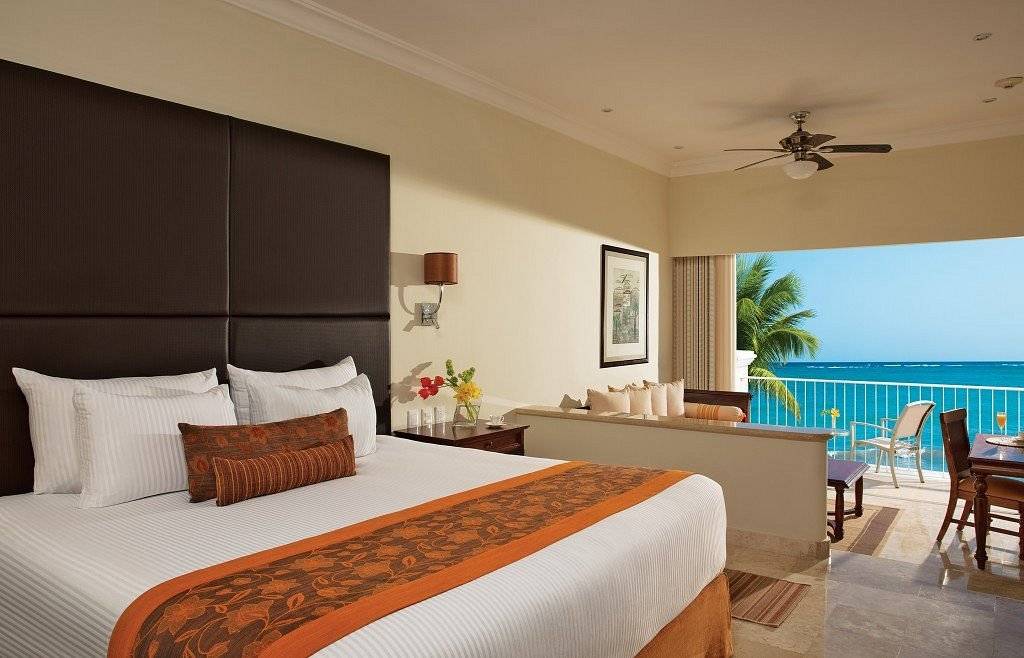 resort room bed with large window facing ocean