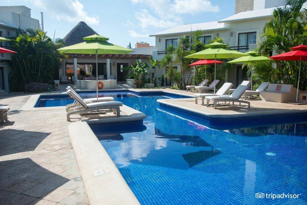 resort pool with green umbrellas