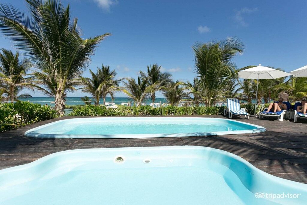 two resort pools surrounded by palm trees