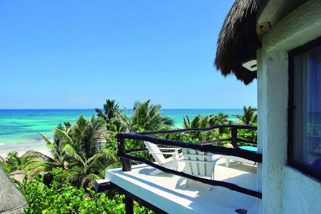 resort balcony overlooking trees to ocean