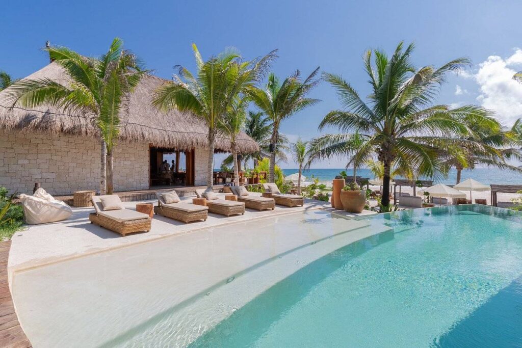 lounge beds alongside beach pool