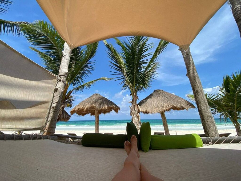man under covering on beach