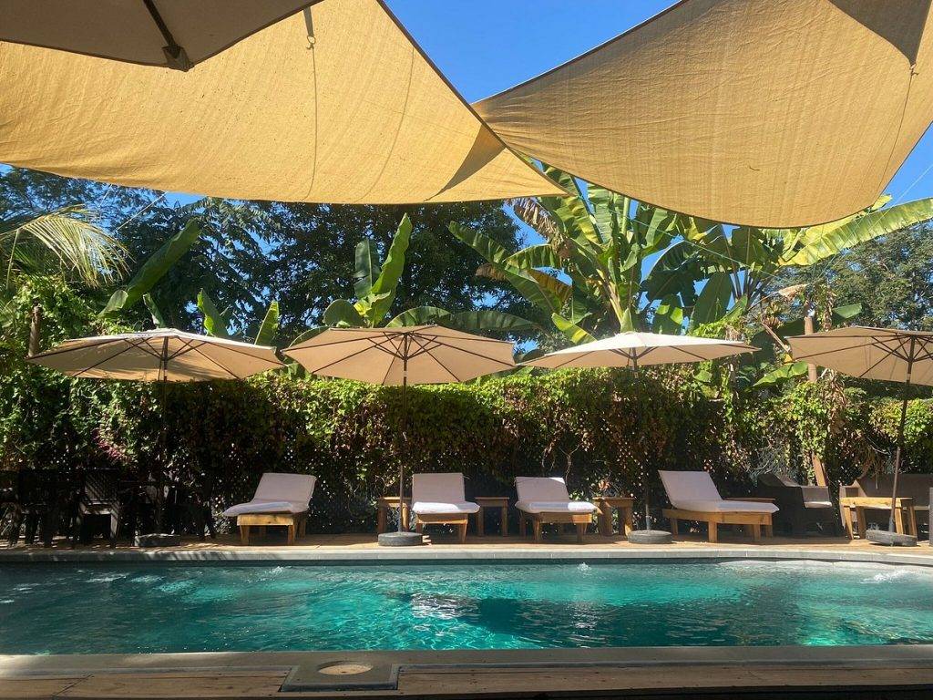 resort pool with lounge chairs and umbrellas