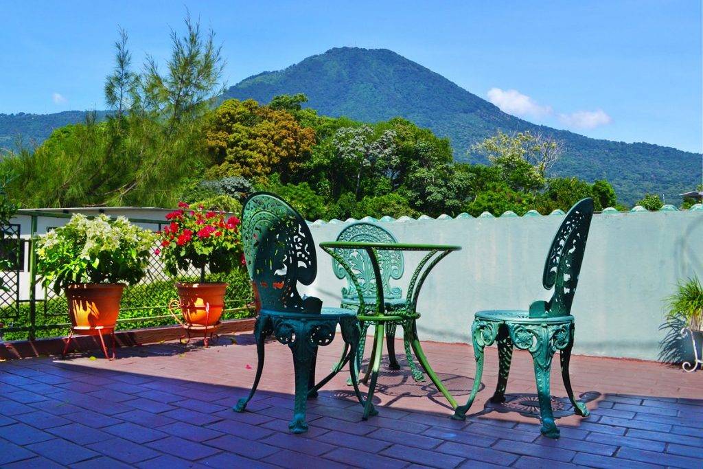 chair and small table with volcano in the background