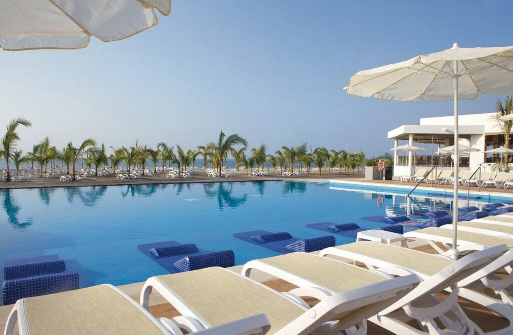 lounge chairs lining resort pool