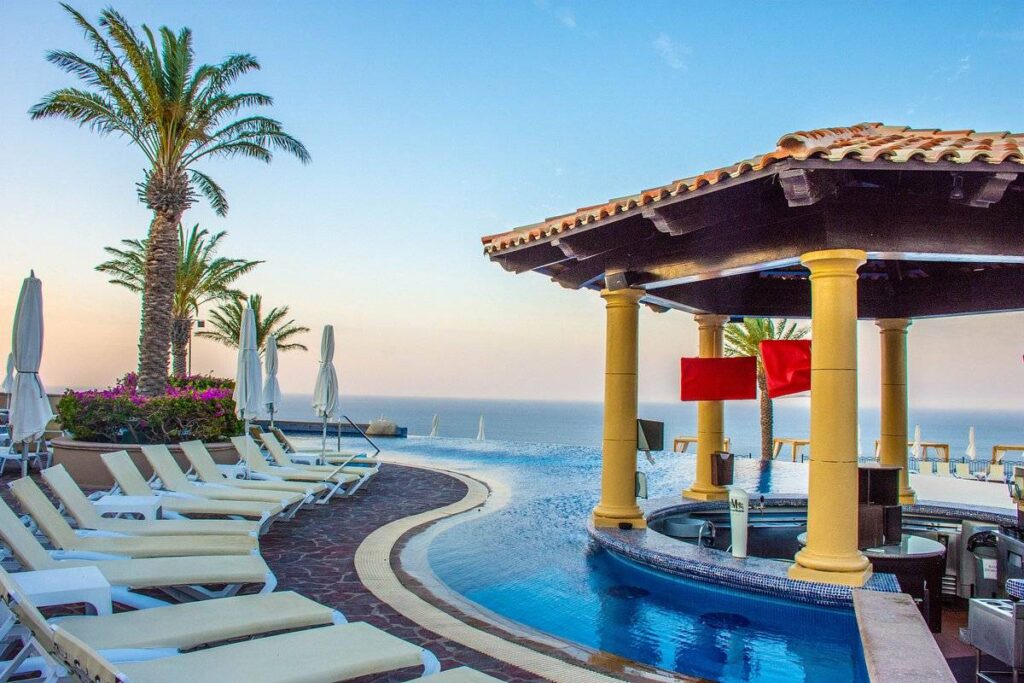 white lounge chairs around pool with swim-up bar