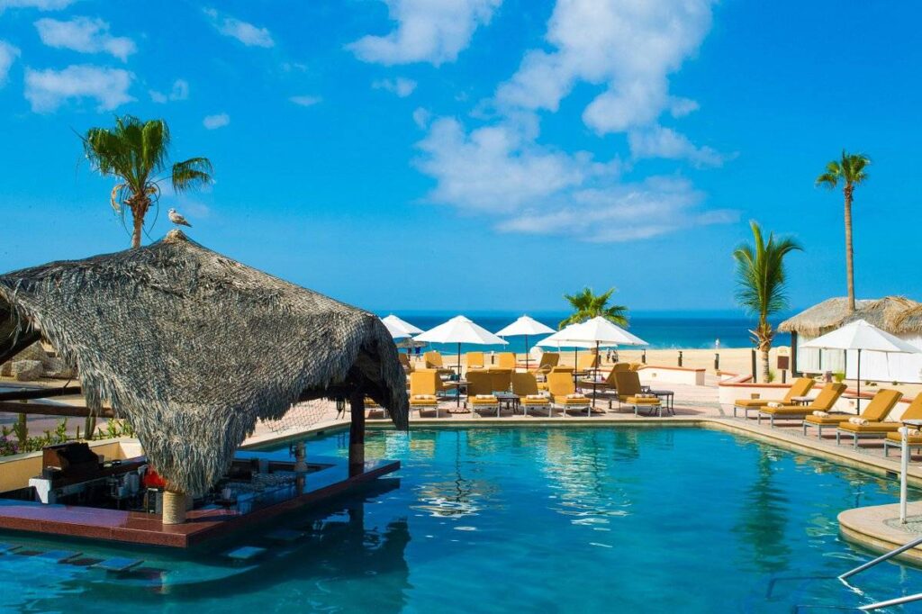 lounge chairs on the beach around pool