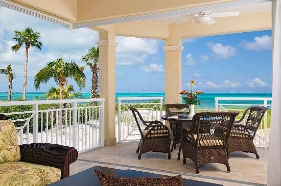 table and chairs under covered patio on beach