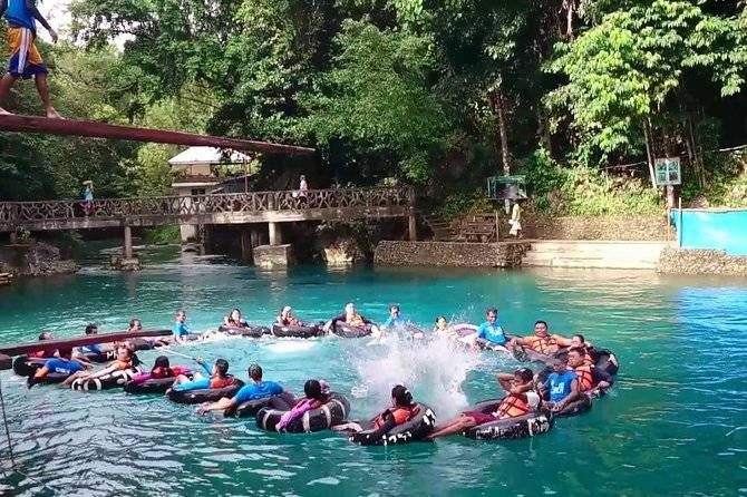 group of people in circle floating in river