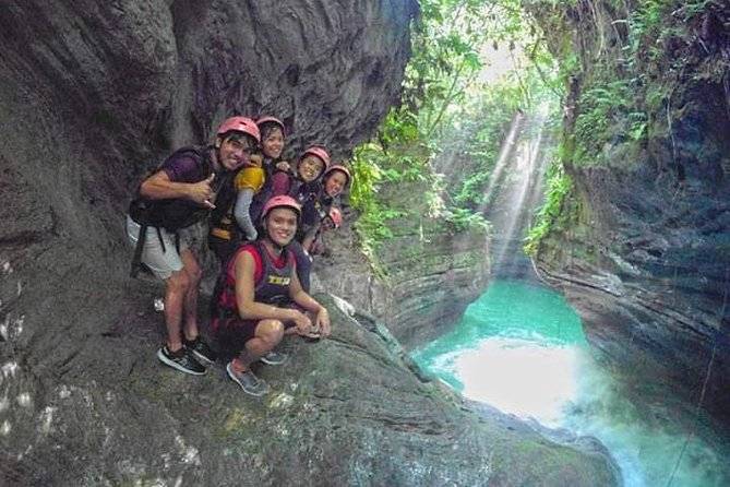 group taking picture near cliff with water below