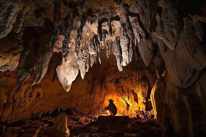 man kneeling in cave