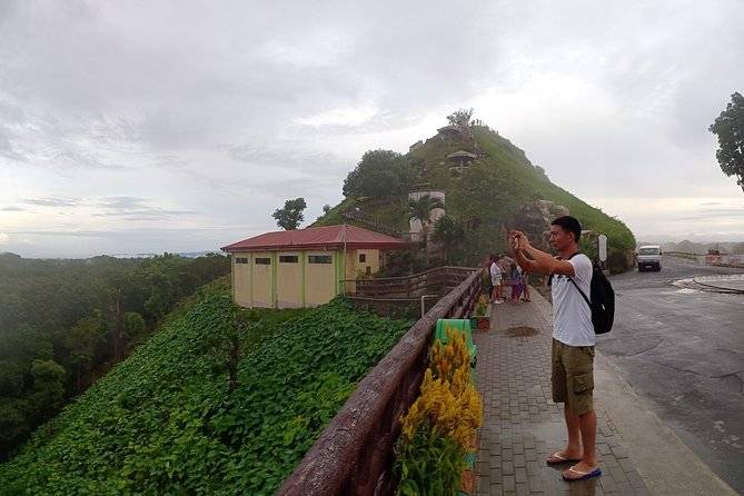 man taking picture from road
