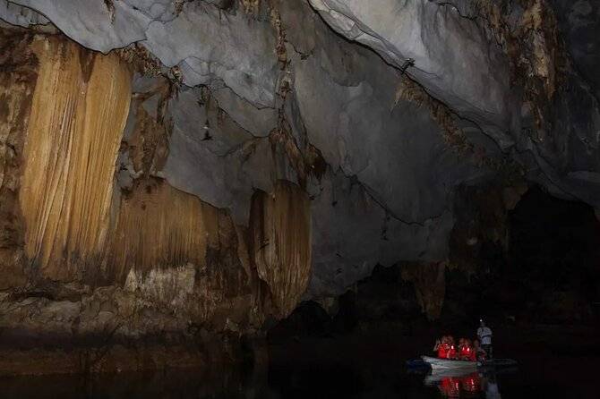 people in boat in a cave