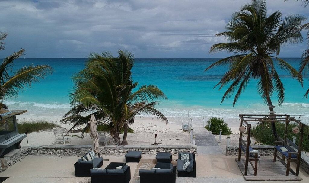 aerial view of beach with furniture and palm trees