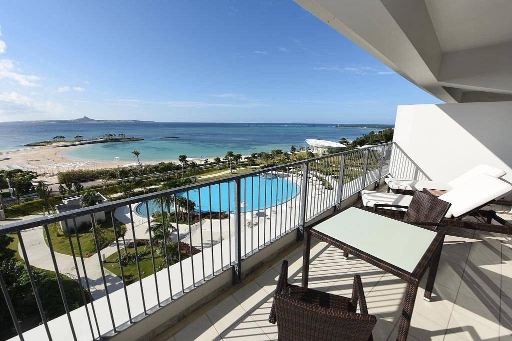 resort balcony overlooking pool and ocean