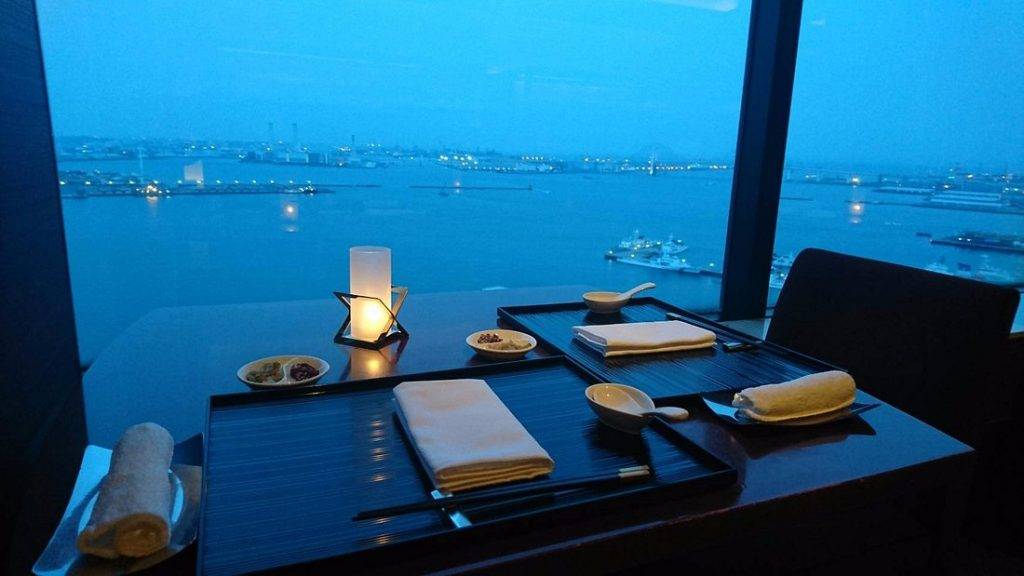 restaurant table next to window looking down at port