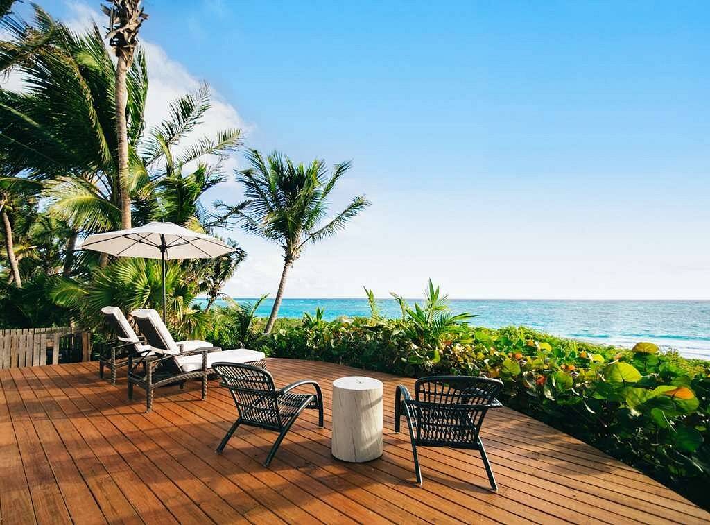 chairs on wooden deck in front of ocean
