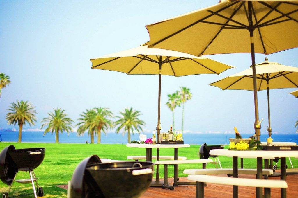 dining tables with yellow umbrellas and palm trees