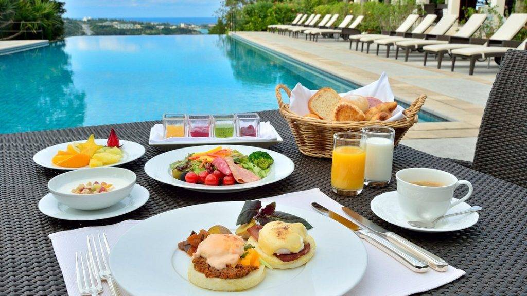 table with breakfast at large resort pool