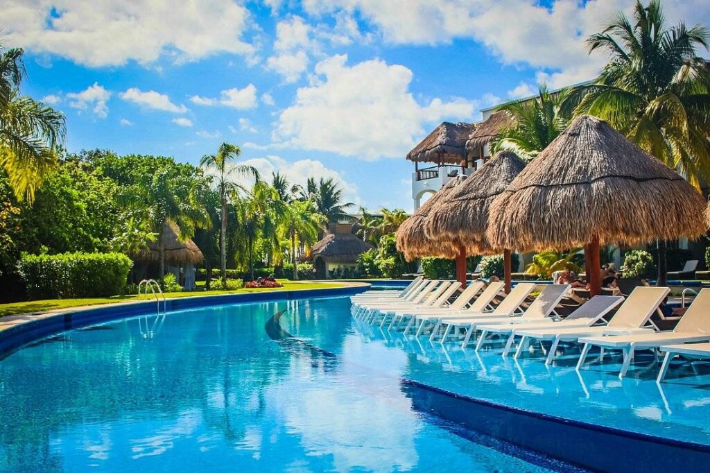 curved resort pool with lounge chairs