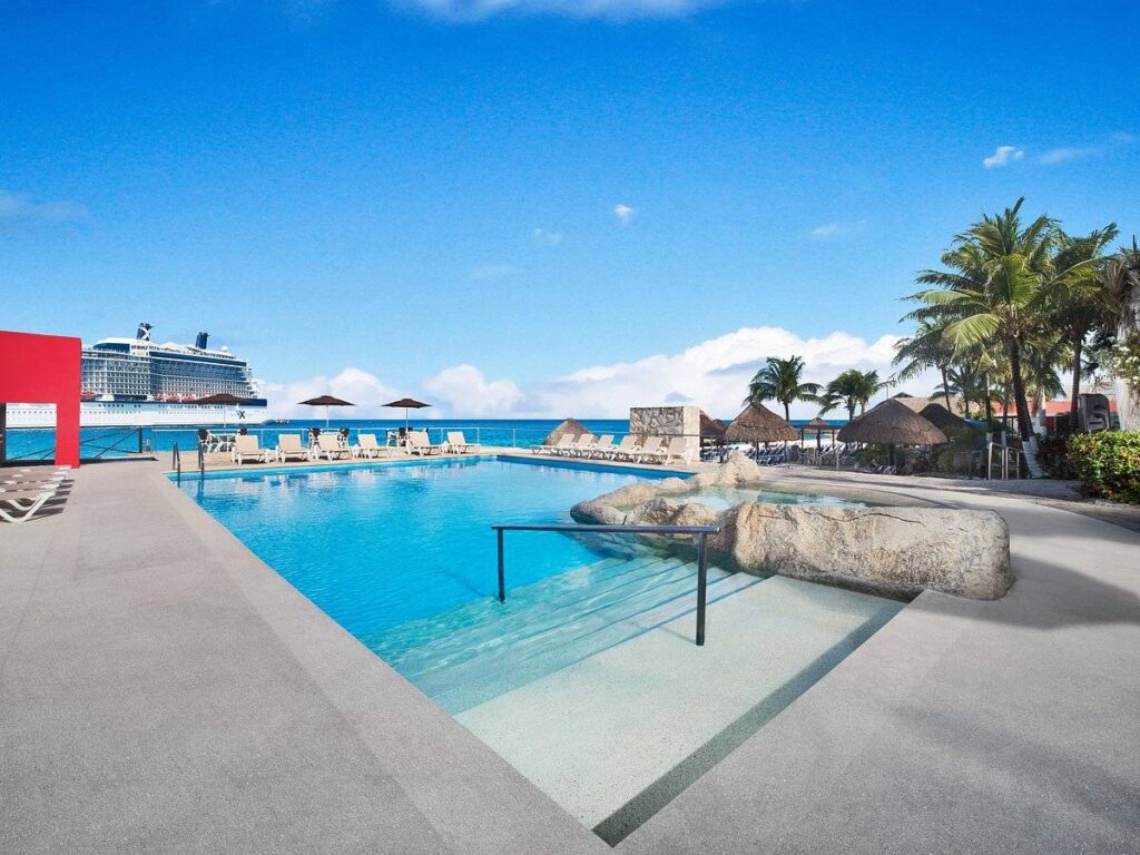 resort pool with cruise ship in background